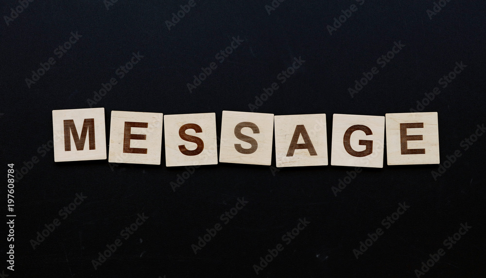 Obraz premium Word MESSAGE on wooden signs over black