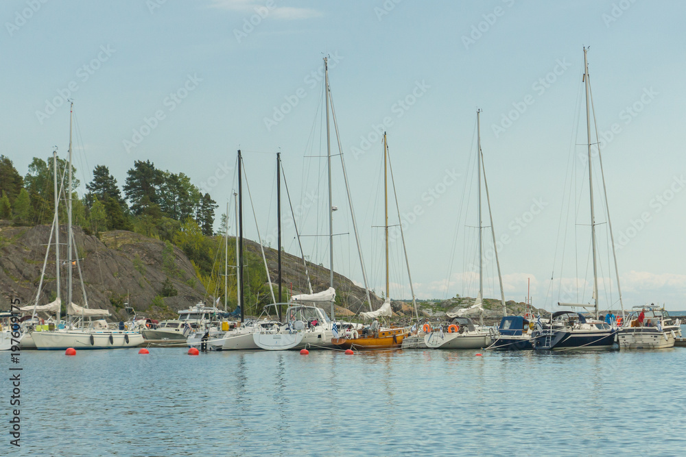 Boats and yachts in the harbour seen from the Vallisaari island on a bright summer day in Southern Finland
