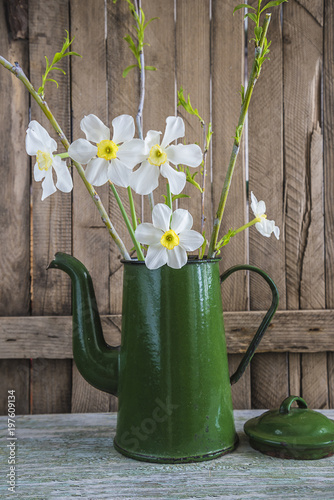 Fototapeta Naklejka Na Ścianę i Meble -  Bouquet of white daffodils in old coffee pot