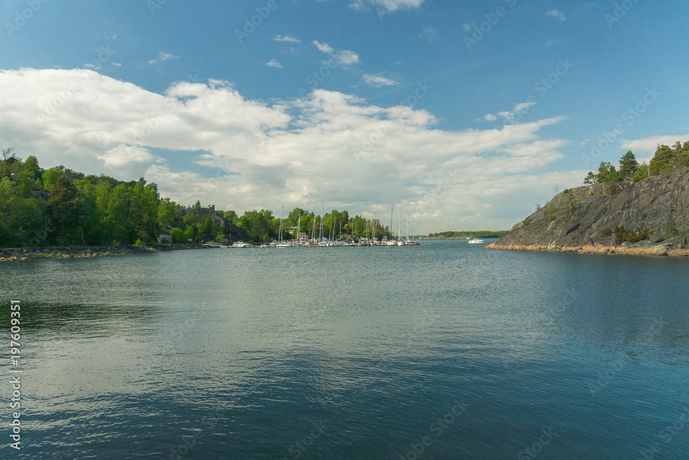 Boats and yachts in the harbour seen from the Vallisaari island on a bright summer day in Southern Finland