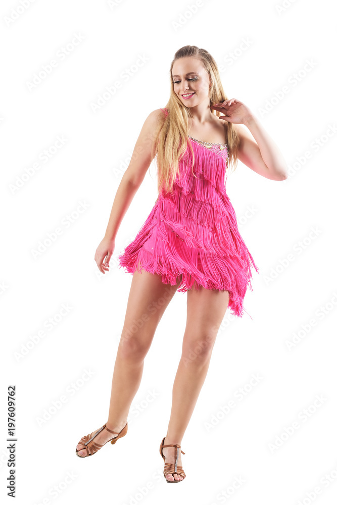 Happy sexy blonde female dancing and touching hair in pink fringed dress. Full body isolated on white background. Happy sexy blonde female dancing and touching hair in pink fringed dress. Full body isolated on white background.