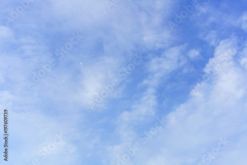 Beautiful white clouds and blue sky with moon for background