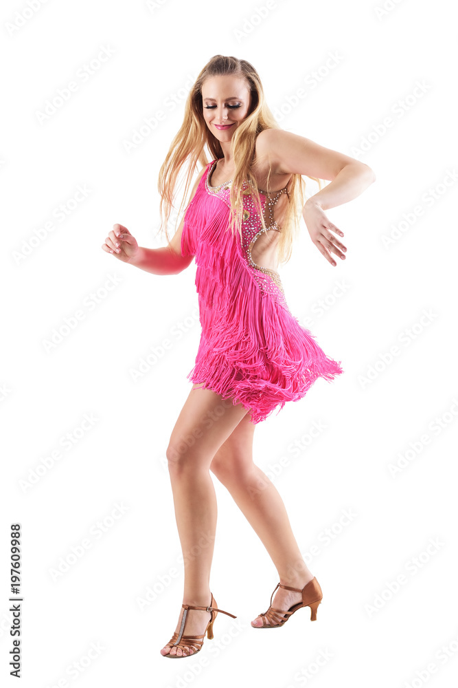 Blonde woman smiling and dancing latino dances in pink fringed costume dress. Side view. Full body isolated on white background.