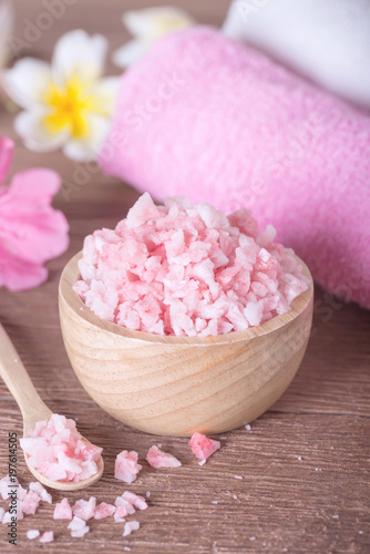 Pink spa salt in wooden bowl with orchid flower and towel. For this photo applied color tone effect.