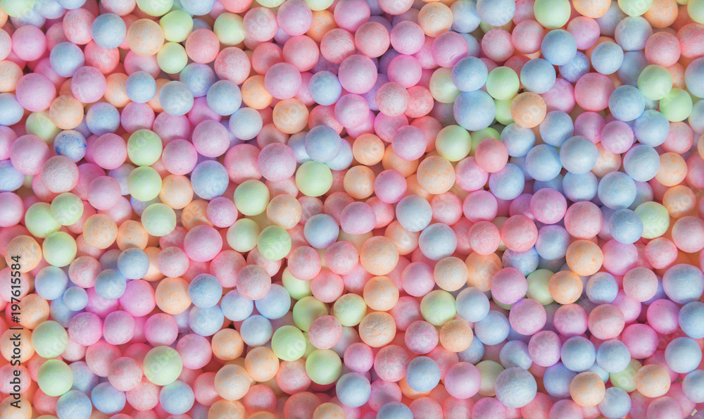 Abstract background from colorful small foam balls patter in box