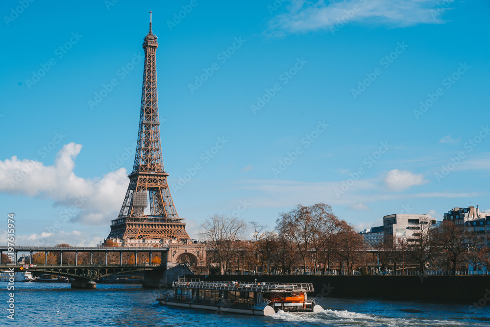 view on Eiffel Tower and boat on river in Paris, France