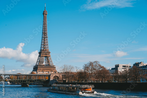 view on Eiffel Tower and boat on river in Paris  France