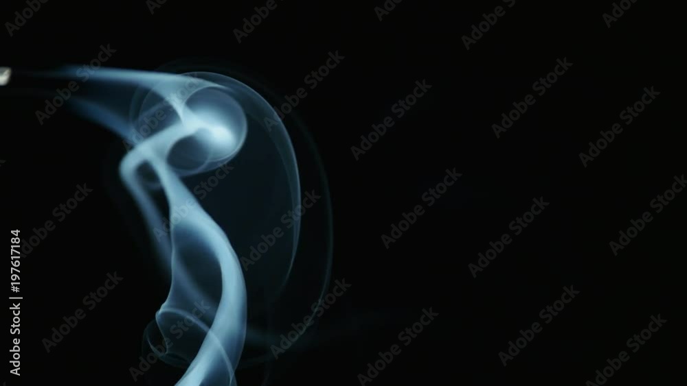 Movement of Incense Smooth Smoke on a dark background. Dynamic Beautiful calm relax concept. Aromatherapy, cleansing incense smoke Movement of Incense Smooth Smoke on a dark background. Dynamic Beautiful calm relax concept. Aromatherapy, cleansing incense smoke