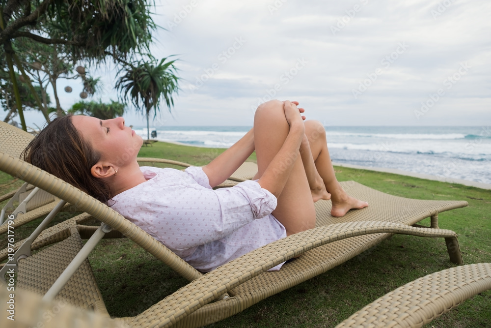 caucasian woman relaxing in chair near indian ocean in Srilanka. Have a good vacation in asia caucasian woman relaxing in chair near indian ocean in Srilanka. Have a good vacation in asia