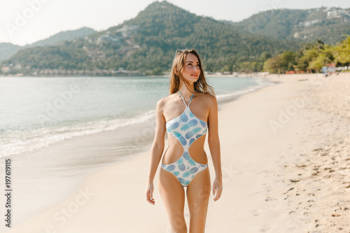 Fotótapéta attractive woman posing in swimsuit on beach on tropical resort
