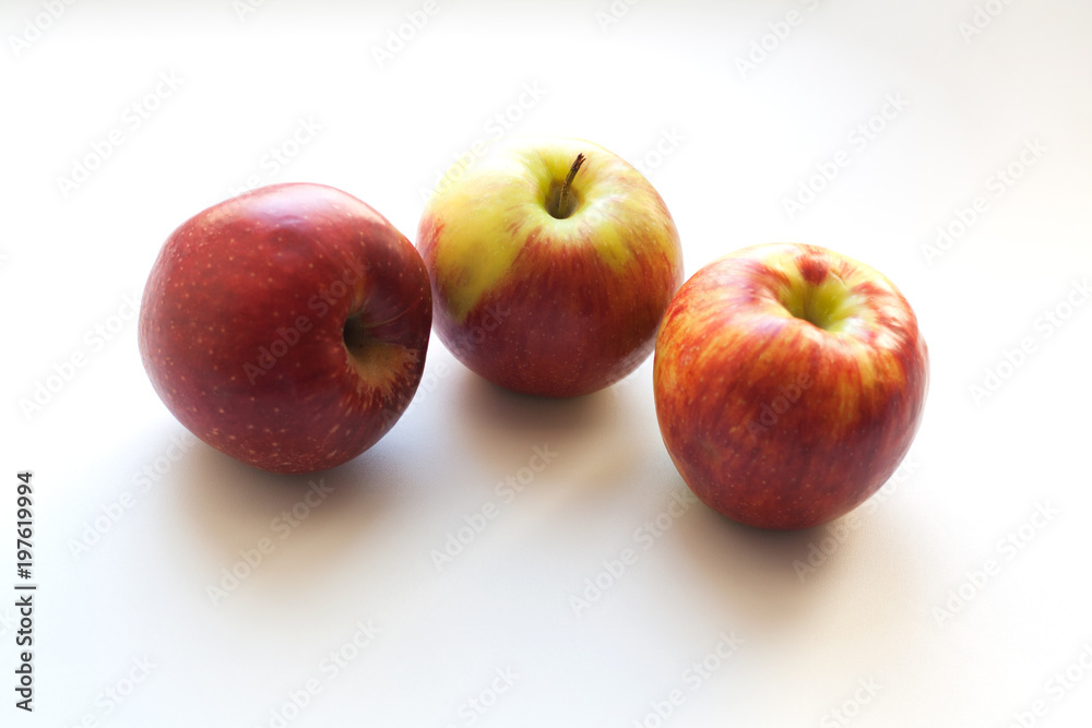 Three ripe red apples isolated on white background