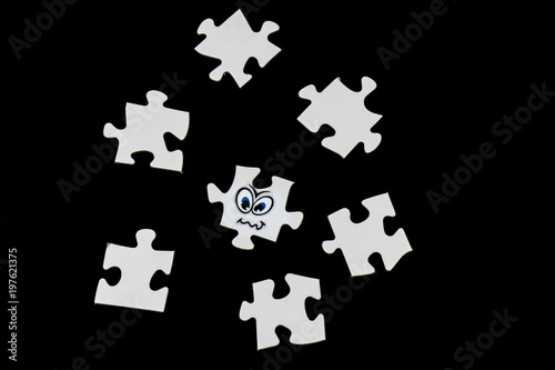 Puzzle pieces with a funny face, black background