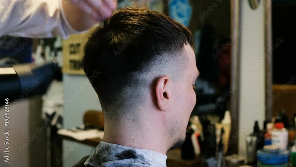 Hairdresser dries hair with a hair dryer man in barbershop Hairdresser dries hair with a hair dryer man in barbershop
