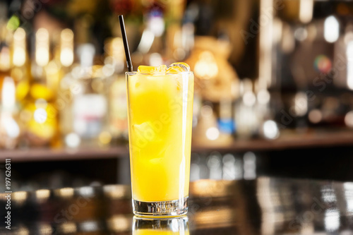 Glass of fresh pineapple juice at bar counter background.