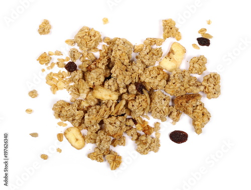 Crunchy granola, muesli pile with banana, pineapple slices, peanuts and raisins isolated on white background