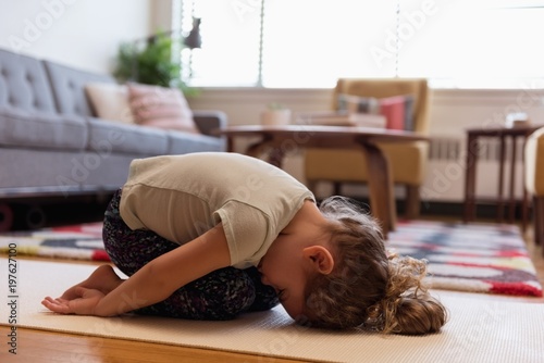 Girl doing meditation in living room