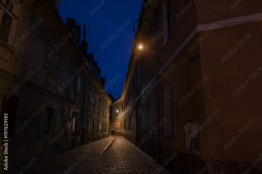 Narrow ancient street of the old city. night photo. Brasov. Romania. Europe.
