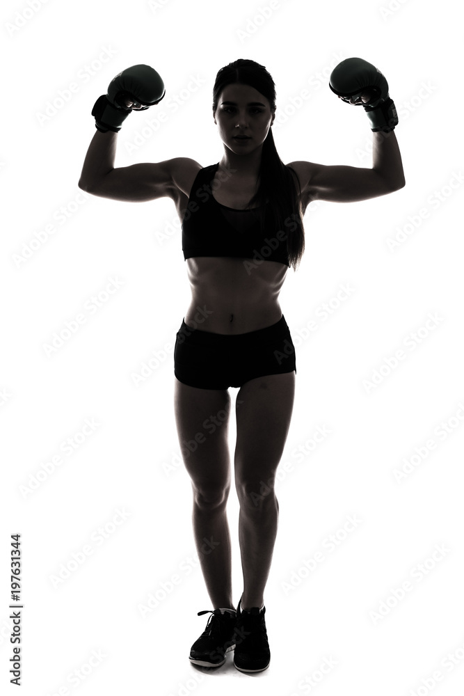 Silhouette sporty woman doing boxing exercises, making direct hit with dumbbells. Photo of muscular female wearing sportswear on white background. Strength and motivation Silhouette sporty woman doing boxing exercises, making direct hit with dumbbells. Photo of muscular female wearing sportswear on white background. Strength and motivation