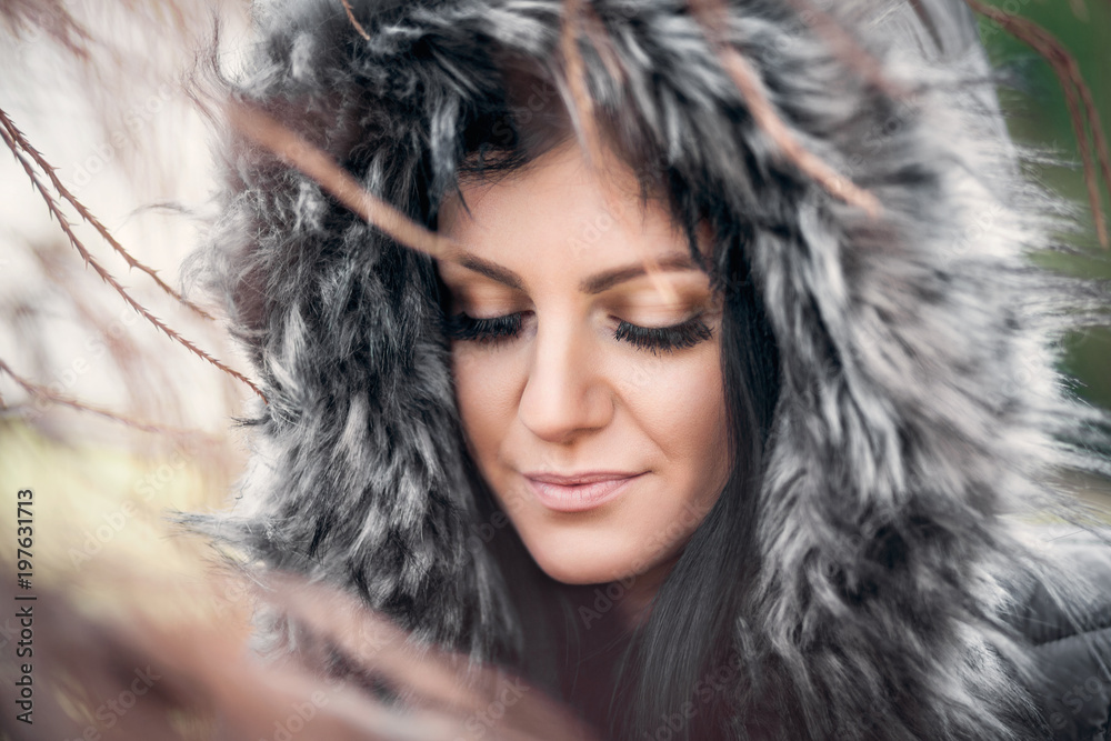 Beautiful woman wearing a fur hood winter coat Beautiful woman wearing a fur hood winter coat