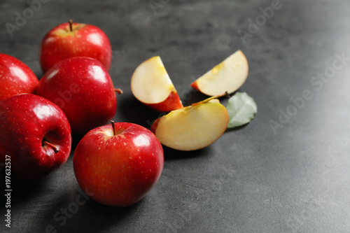 Fresh ripe red apples on grey background