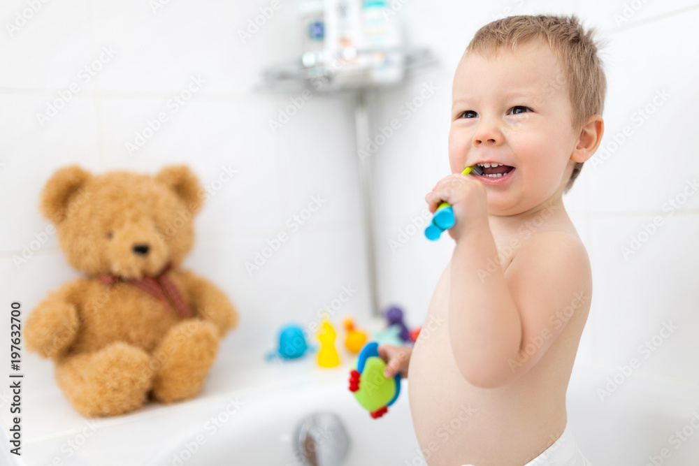 Adorable child learing how to brush his teeth Adorable child learing how to brush his teeth