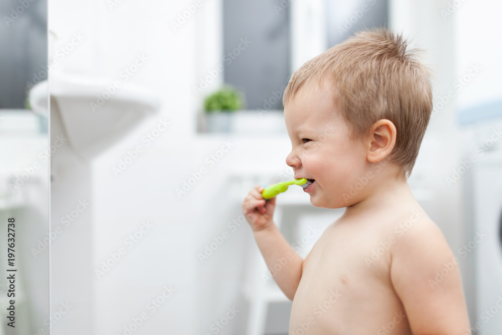 Adorable child learing how to brush his teeth Adorable child learing how to brush his teeth