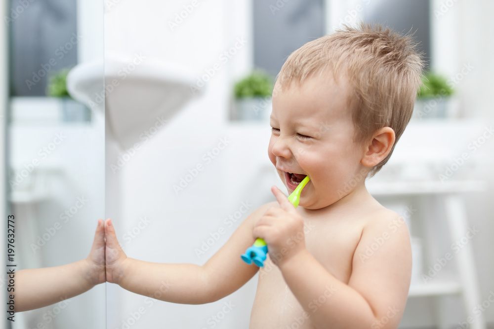Adorable child learing how to brush his teeth Adorable child learing how to brush his teeth