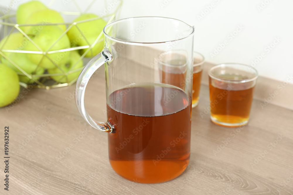 Jug with fresh apple juice on wooden table Jug with fresh apple juice on wooden table