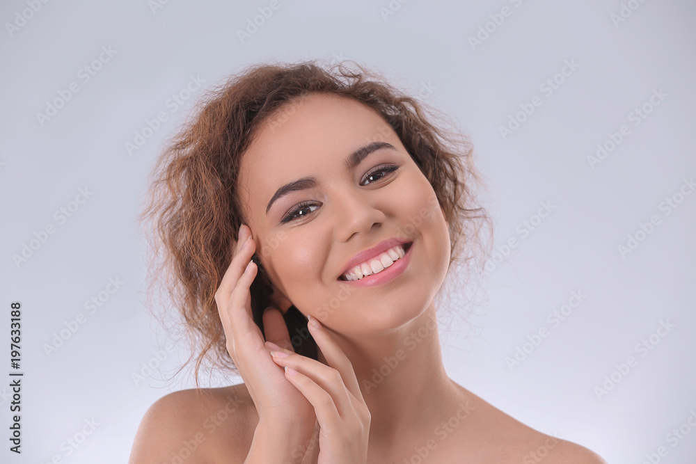 Beautiful young woman with acne problem on light background Beautiful young woman with acne problem on light background