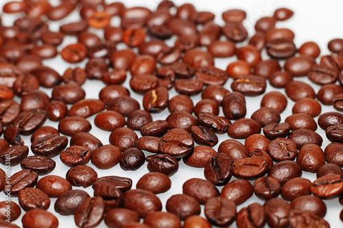 Grains of roasted coffee on a white background