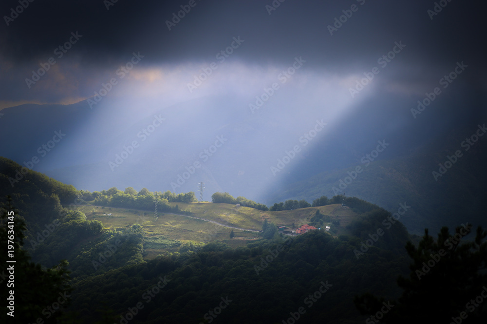 Ray of sunlight on a hill near the Sanctuary of Nostra Signora della Guardia near Genoa, Liguria, Italy Ray of sunlight on a hill near the Sanctuary of Nostra Signora della Guardia near Genoa, Liguria, Italy