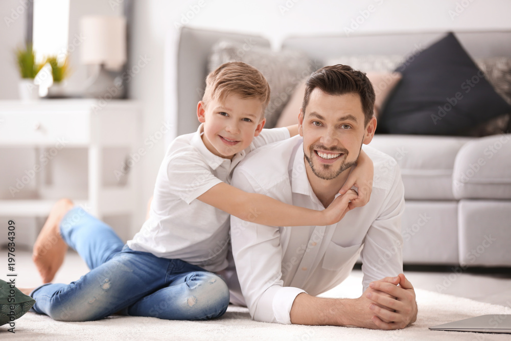 Little boy and his dad spending time together at home