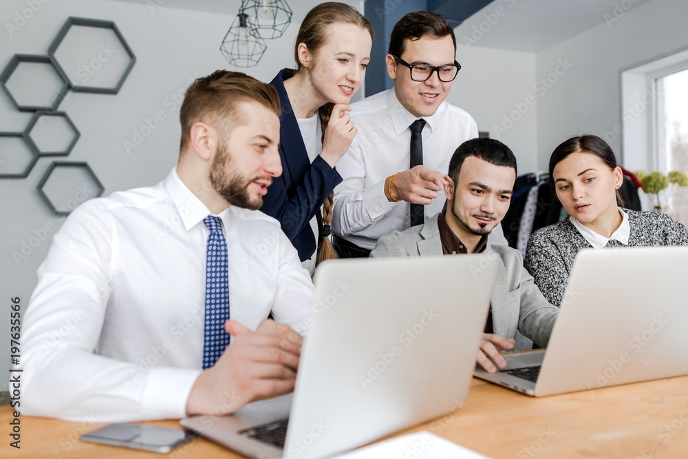 Group of businessmen working with a laptop denouncing investing Group of businessmen working with a laptop denouncing investing
