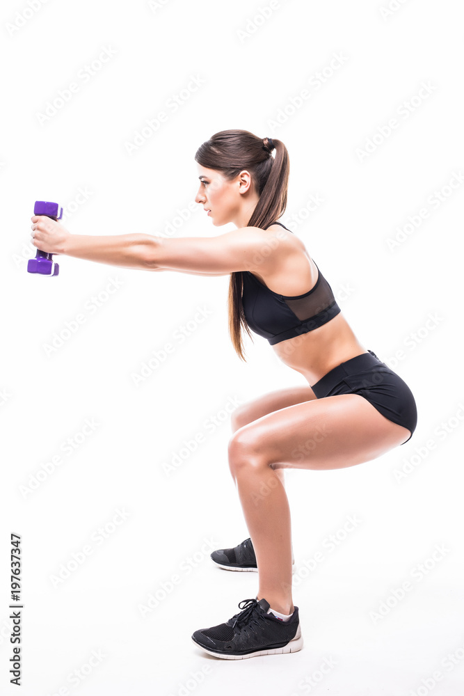 Young sporty muscular woman doing squats isolated over white background. Woman in sport clothing performing exercise