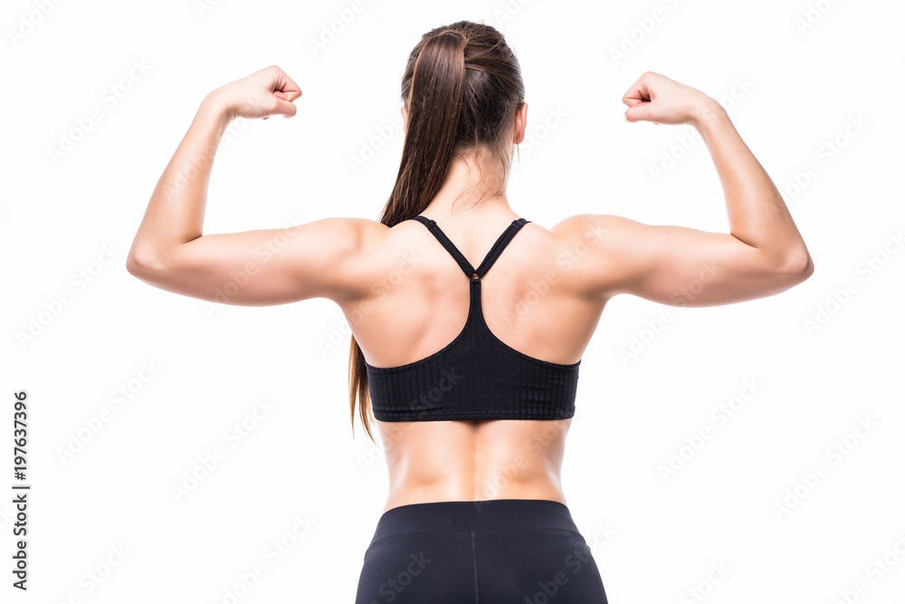 Athletic young woman showing muscles of the back and hands on