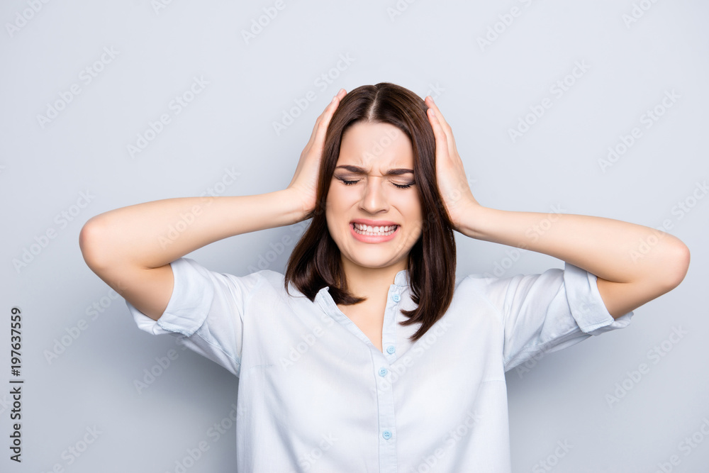 Pretty, charming, stylish woman touching compress her head with two hands, having close eyes and clench her teeth, suffering from hurt, routine, full of everything, isolated on grey background Pretty, charming, stylish woman touching compress her head with two hands, having close eyes and clench her teeth, suffering from hurt, routine, full of everything, isolated on grey background