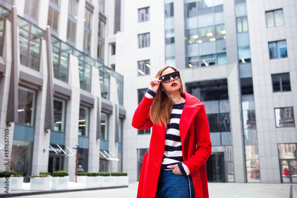 Fototapeta premium Young charming woman in fashionable sunglasses looking away.Street fashion concept.
