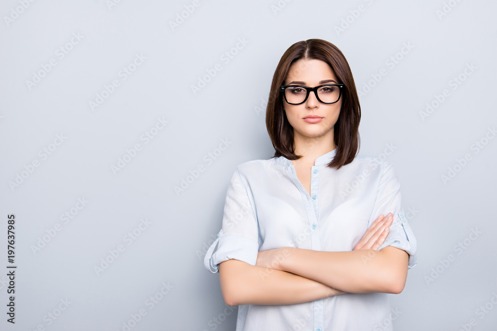 Portrait with copy space, empty place of caucasian, nice, cute, concentrated, thoughtful, modern girl with short hair having her arms crossed, isolated on grey background, looking at camera Portrait with copy space, empty place of caucasian, nice, cute, concentrated, thoughtful, modern girl with short hair having her arms crossed, isolated on grey background, looking at camera