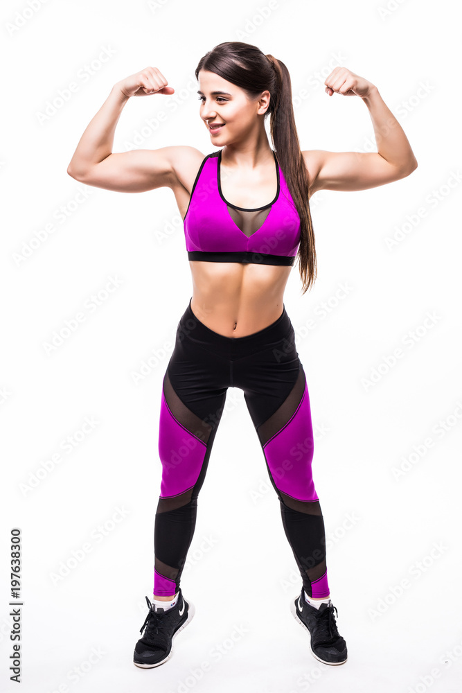 Full height of smiling sports woman flexing biceps and looking at camera isolated over white background Full height of smiling sports woman flexing biceps and looking at camera isolated over white background