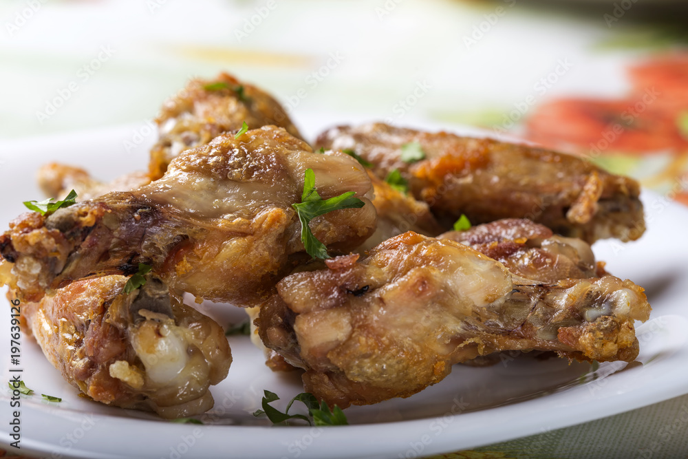 Close up of fresh Grilled chicken drumsticks with parsley leaves Close up of fresh Grilled chicken drumsticks with parsley leaves