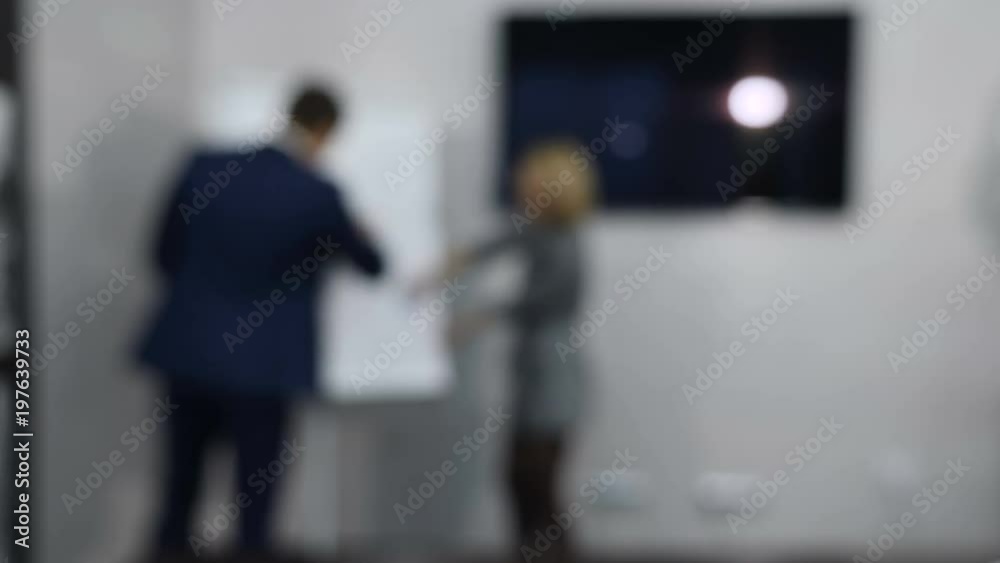 Blurred, defocused, blur video. Successful business team busy working on a hand drawn graph on a flip chart. Planning, Discussing. Shot in 4k Blurred, defocused, blur video. Successful business team busy working on a hand drawn graph on a flip chart. Planning, Discussing. Shot in 4k