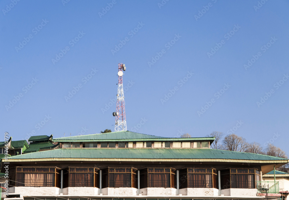 Obraz premium A roof of the houses and mobile tower