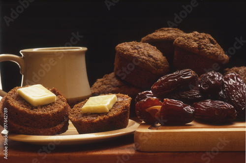 Date Bran Muffins Pictured with Dried Dates, Coffee Cup and Plate 