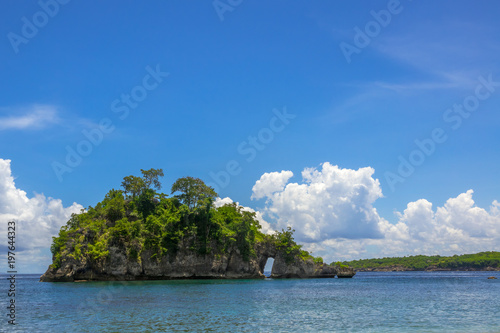 Rocky Island with Forest, Blue Sky and Beautiful Clouds