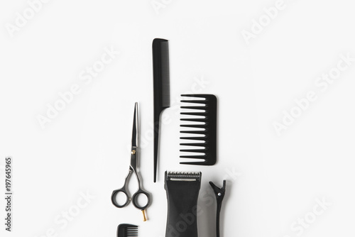 flat lay with hair machine and hairdressing tools, on white