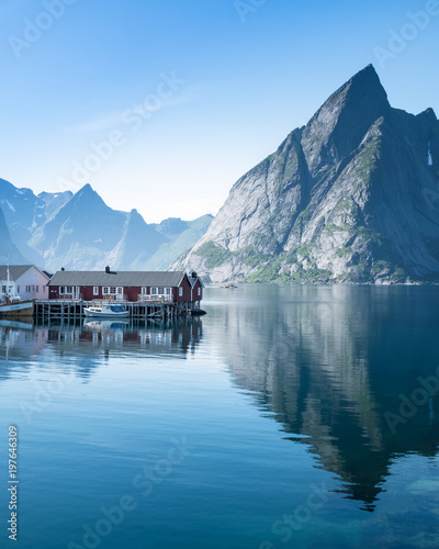 Scenic landscape with mountains and idyllic village at bright summer day in Lofoten Islands, Norway