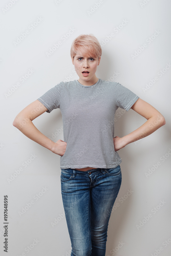 Angry attractive young woman with hands on hips Angry attractive young woman with hands on hips