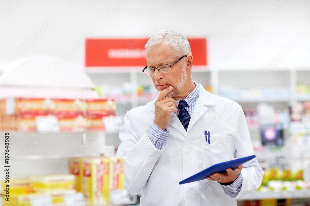 medicine, healthcare and technology concept - senior apothecary with tablet pc computer at pharmacy medicine, healthcare and technology concept - senior apothecary with tablet pc computer at pharmacy