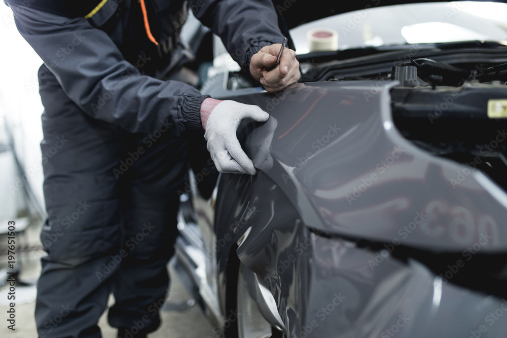 Car wrapping specialist putting vinyl foil or film on car. Car wrapping specialist putting vinyl foil or film on car.