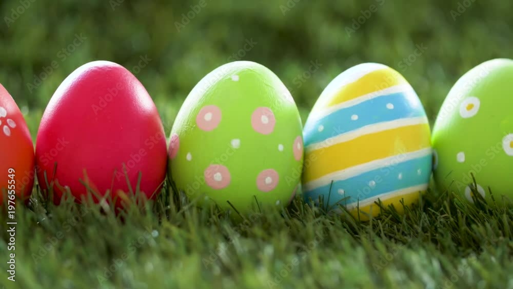 easter, holidays, tradition and object concept - row of colored eggs on artificial grass easter, holidays, tradition and object concept - row of colored eggs on artificial grass
